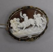 An early 20th century yellow metal and carved cameo oval brooch, 65mm.