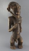 An African carved wood figure of a standing bearded man, 52cm