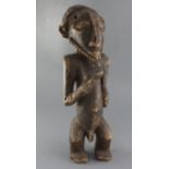 An African carved wood figure of a standing bearded man, 52cm