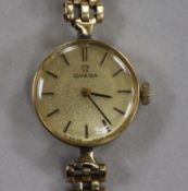 A lady's 9ct gold Omega manual wind wrist watch, on 9ct gold bracelet.