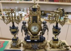 A 20th century gilt and putti clock garniture clock width 33cm height 62cm