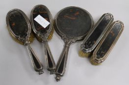 A George V silver and tortoiseshell five piece dressing table set.