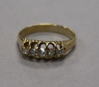 A yellow metal and graduated five stone diamond ring, size K.