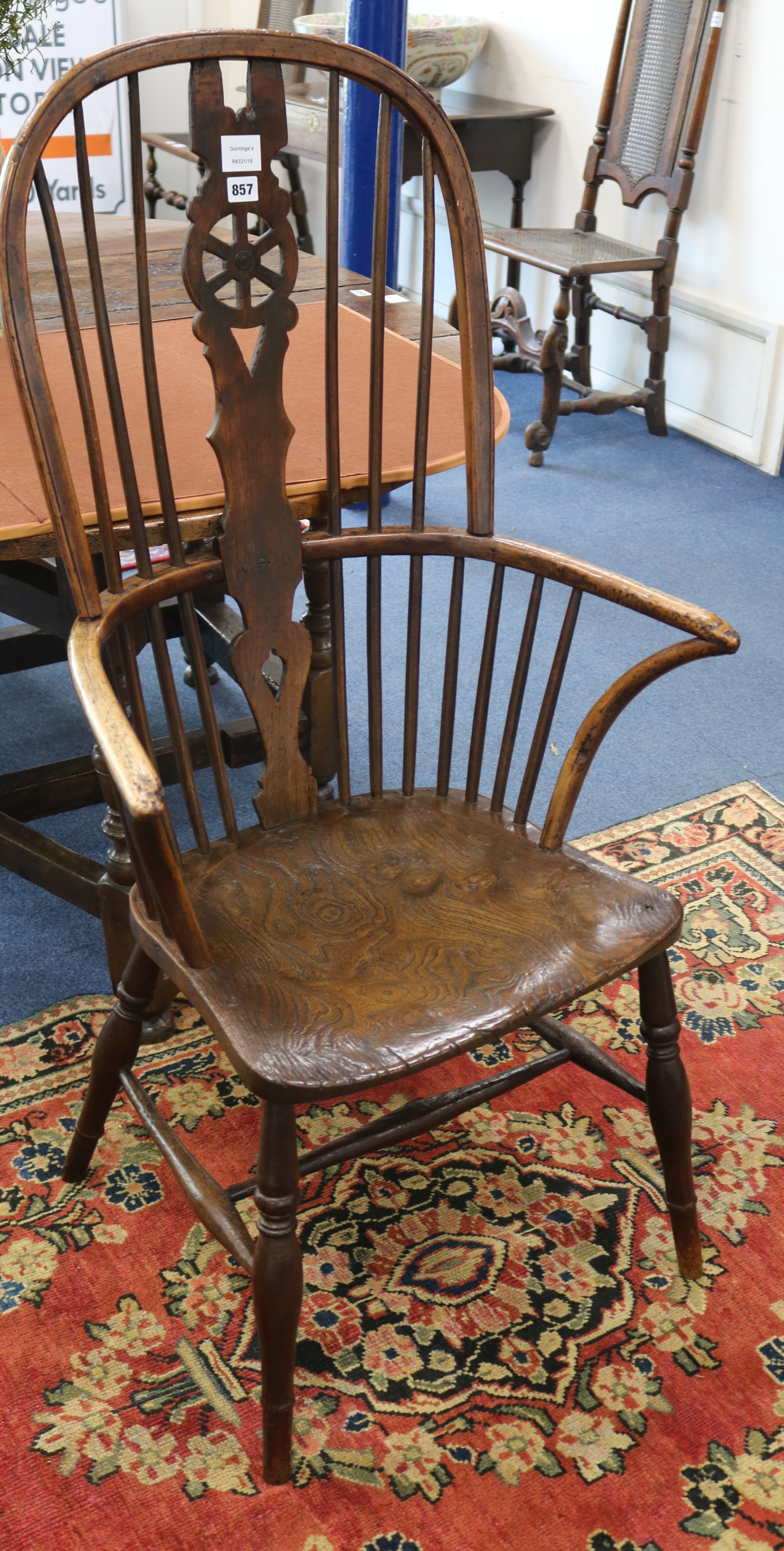 A late 18th century elm and ash wheelback elbow chair