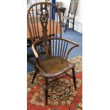 A late 18th century elm and ash wheelback elbow chair
