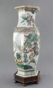 A Chinese famille verte hexagonal baluster vase, late 19th century, painted with a continuous