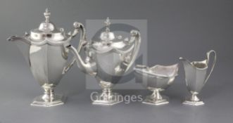 A George V silver four piece silver tea set, by Walker & Hall, of hexagonal form, with reeded wavy