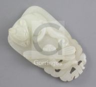 A Chinese pale celadon jade pendant, 19th century, carved in high relief with the figure of a cat