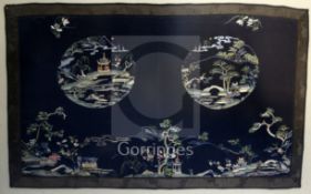 A Chinese embroidered silk panel, late Qing dynasty, decorated with double landscape medallions