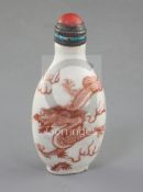A Chinese iron red enamelled 'dragon' snuff bottle, 19th century, of flattened ovoid form, the