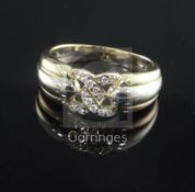 A 1980's Cartier three colour gold and diamond set ring, with pierced central motif and numbered