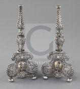 A pair of antique continental silver filigree and gem set bases, (ex-candlesticks?), with