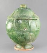 A Chinese green glazed pottery jar and cover, Yuan dynasty (1271-1368), the globular body and