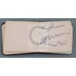 The Beatles: A small red leather bound autograph album with assorted autographs but principally