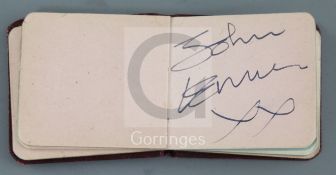 The Beatles: A small red leather bound autograph album with assorted autographs but principally