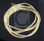 An Italian textured 18ct gold multi strand bracelet, approx. 18.3cm.