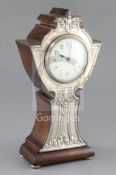 An early 20th century silver mounted mantel timepiece, Birmingham 1909, the shaped wooden case