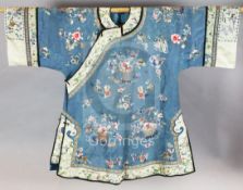 A Chinese embroidered silk robe, late 19th century, woven with baskets and jardinieres of flowers on