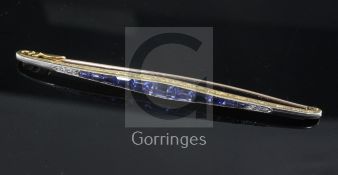 A 1920's gold, sapphire and diamond bar brooch, of tapering form, set with shaped cut sapphires