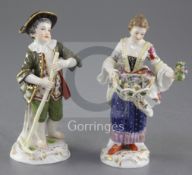 Two Meissen figures of gardeners, late 19th century, the first a boy holding a rake, the second a