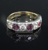 A modern 18ct gold, ruby and diamond seven stone half hoop ring, size Q.