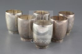 A set of six 1930's Georg Jensen Danish sterling silver beakers, no. 222A, of planished