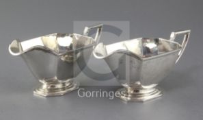 A pair of George V silver sauceboats by Barker Brothers Silver Ltd, of panelled form with angular
