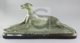 M. Fiot. A bronze model of a greyhound lying upon naturalistic base, signed, on black marble plinth,