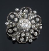 An Edwardian gold, silver and diamond cluster flower head pendant brooch, 28mm.