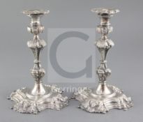 An ornate pair of 1960's Irish cast silver candlesticks by Royal Irish Silver Ltd, with engraved