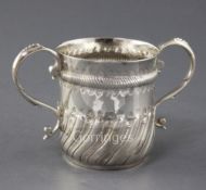 A George II repousse silver porringer, with typical decoration and S scroll handles, maker's mark