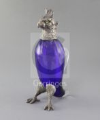 A late Victorian silver plate mounted blue glass novelty claret jug, modelled as a parrot, with