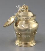 A 1930's silver gilt tea caddy and cover, with matching caddy spoon, by Goldsmiths & Silversmiths Co