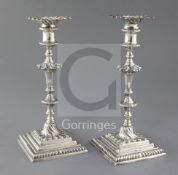 A pair of George III cast silver candlesticks by Ebenezer Coker, with turned waisted stems, on