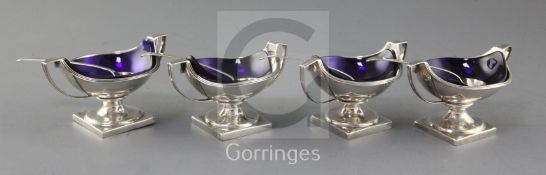 A matched set of four (two pairs) George III silver two handled circular pedestal salts, Peter,