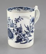 A Lowestoft blue and white cylindrical mug, c.1770, painted with floral sprays and a butterfly,