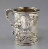 A Victorian silver mug by Thomas Smily, with engraved armorial and embossed with flowers and
