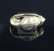 An antique yellow metal ring, the oval head carved with initials, possibly Roman, tests as high