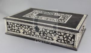 An 18th century Indo Portuguese ebony and ivory casket, decorated with bands of flowering foliage