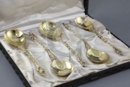 A cased set of four Victorian silver gilt "apostle" serving spoons and matching sifter spoon by