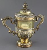 A George II silver gilt two handled presentation cup and cover by Thomas Whipham, with acanthus leaf