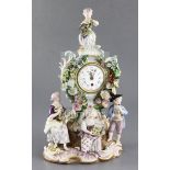 A Meissen porcelain mantel clock case, 19th century modelled with four figures holding fruit,