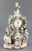 A Meissen porcelain mantel clock case, 19th century modelled with four figures holding fruit,