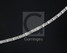 An 18k white gold and diamond line bracelet, set with eighty four round cut diamonds and sixty three