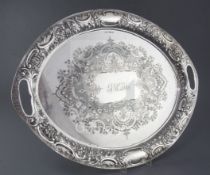 An ornate late Victorian silver oval tray by John Henry Potter, with engraved decoration and