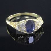 An 18ct gold, sapphire and diamond ring, the central oval sapphire flanked by six round cut