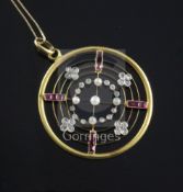 A mid 20th century gold, rose cut diamond, ruby and seed pearl set circular openwork pendant, with