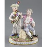 A Meissen group of a young couple, late 19th century, the lady playing a mandolin and the young