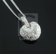 A modern 18ct white gold and pave set diamond heart shaped pendant, on an 18ct white gold chain,