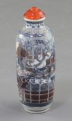 A Chinese underglaze blue and copper red snuff bottle, 19th century, painted with acrobatic